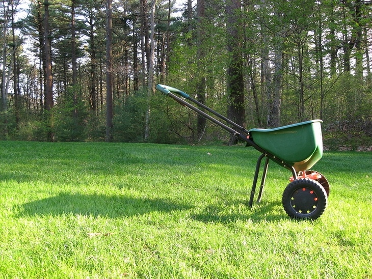 A push-type broadcast spreader is used in most households