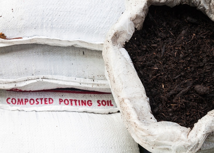 A big white bag of composted potting soil