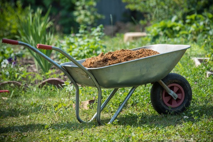 A wheelbarrow can be used to carry garden soil