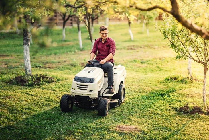 Driving a riding lawn mower is similar to driving other vehicles, with the driver sitting on the top of the deck