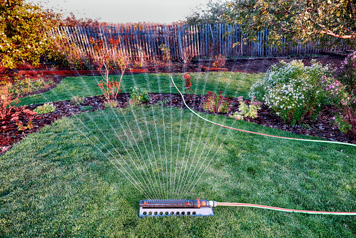 An oscillating lawn sprinkler provides ease and convenience in watering large areas of lawns and gardens