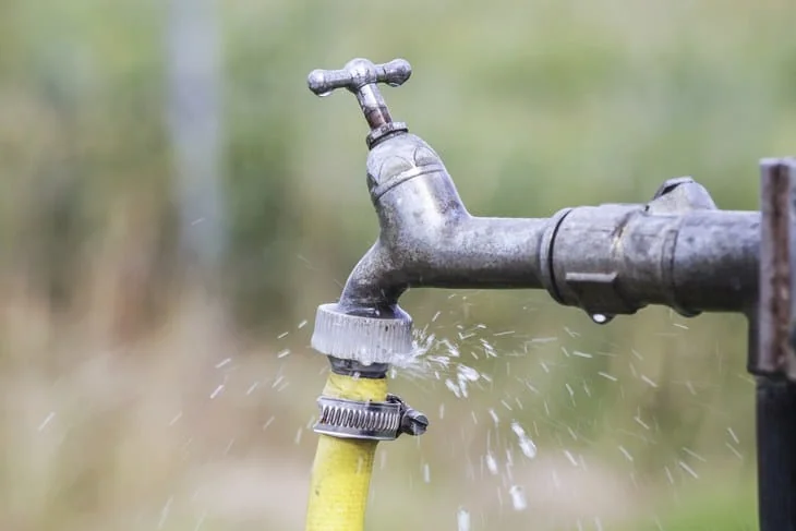 Defective faucet. Water tap spilling water