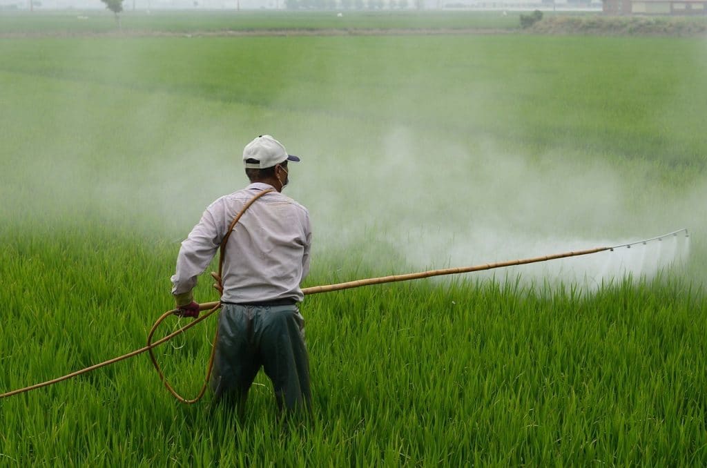 farmer spraying pesticide