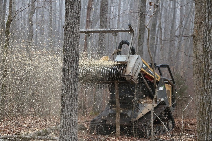 A commercial chipper shredder looks like a tractor with sharp blades and brushes