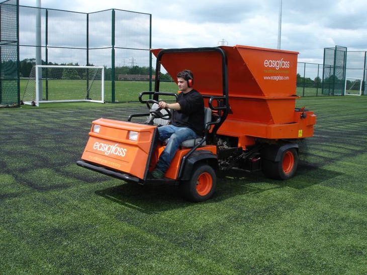 A commercial drop spreader used in a soccer field