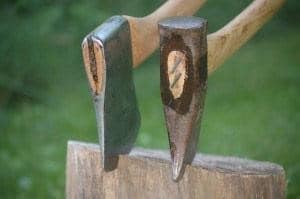 The splitting maul (right) can split wood across the grain
